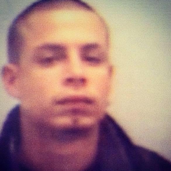 Young Gregory G. Camacho in a faded, low-resolution photo with a serious expression